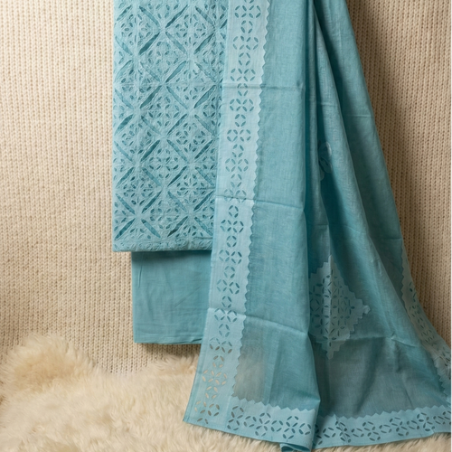 Light blue applique suit set material with cutwork patterns on a beige background