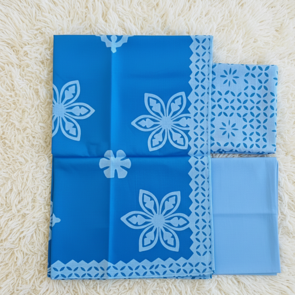 Blue applique suit set fabrics on a beige surface