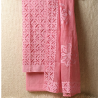 pink applique cutwork suit set material with geometric cutwork pattern on a light beige background
