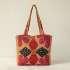 applique Tote bag with floral pattern on a plain background