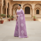 Woman in a purple applique saree with floral cutwork patterns standing in an ornate architectural setting.