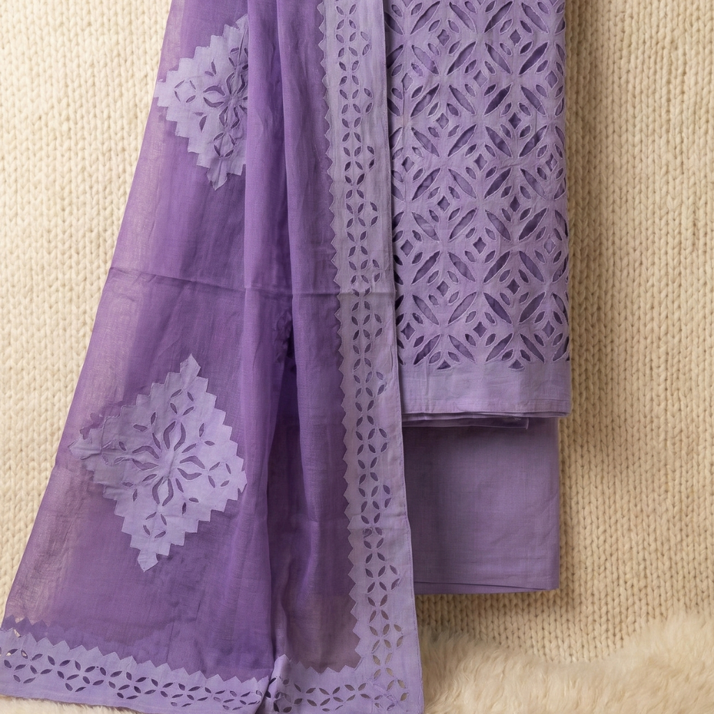 Purple applique suit fabric set with floral patterns and geometric designs on a beige background