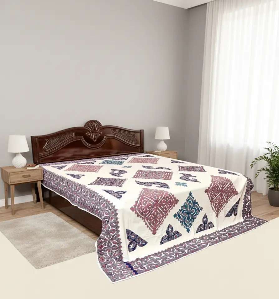 Bed with a geometric applique bedsheet in a bedroom setting
