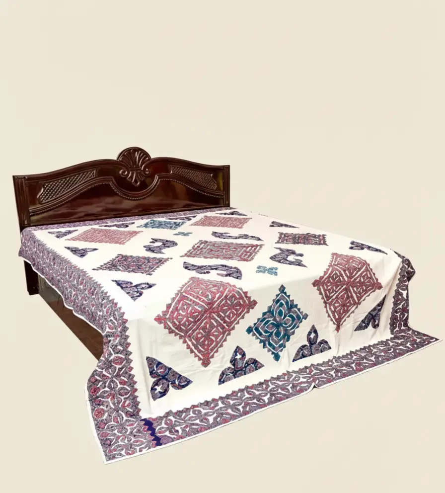 Bed with a patterned applique bedspread 
