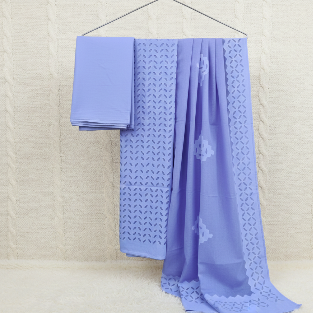 Light blue applique fabric suit set with intricate patterns on a beige background
