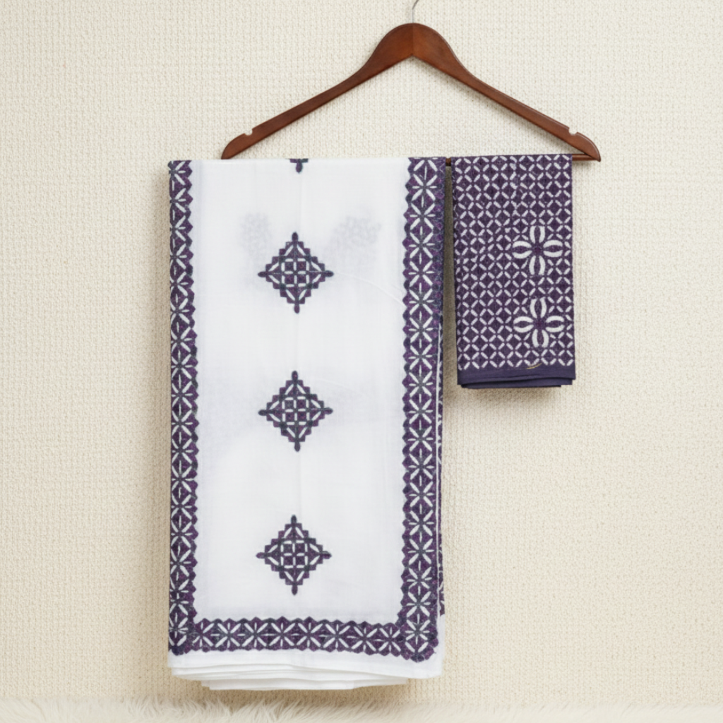White applique suit fabric set with purple geometric patterns on a hanger against a beige background